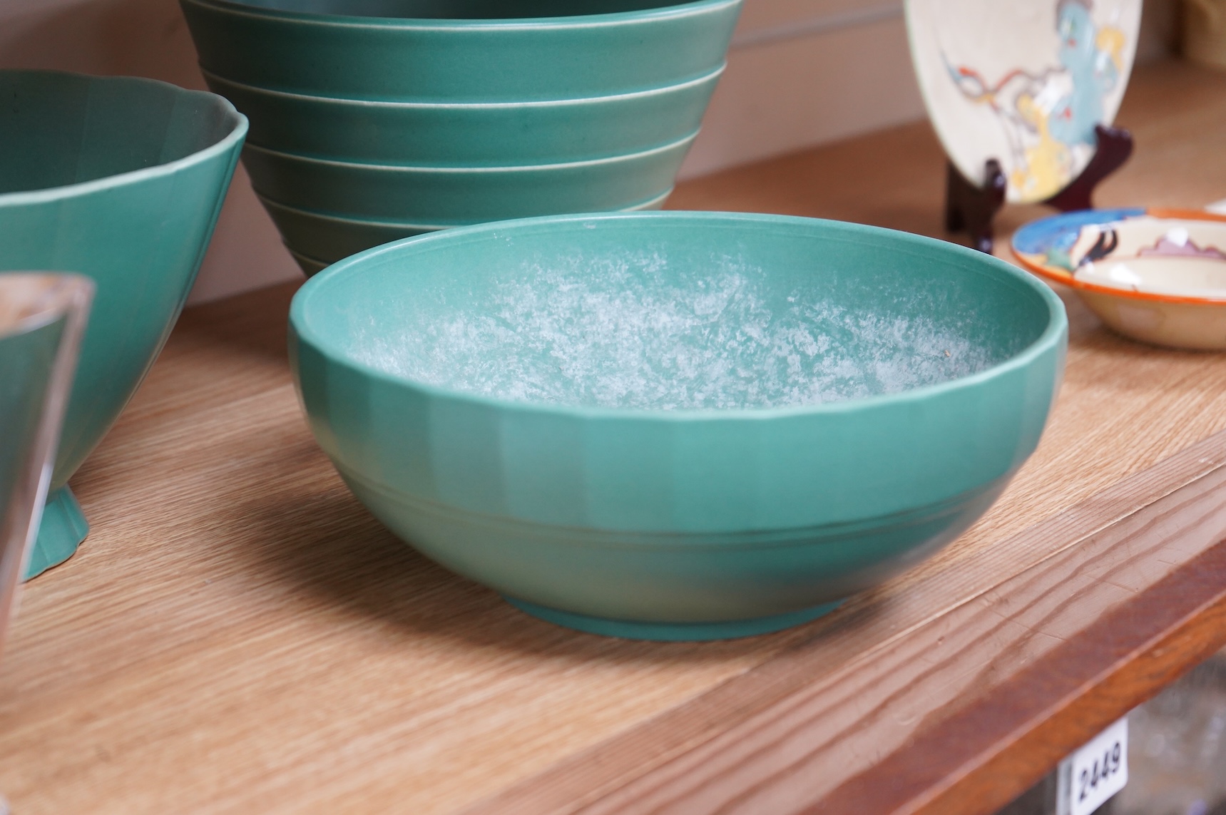 Keith Murray for Wedgwood, three green glazed bowls to include a ribbed example, largest 24cm in diameter